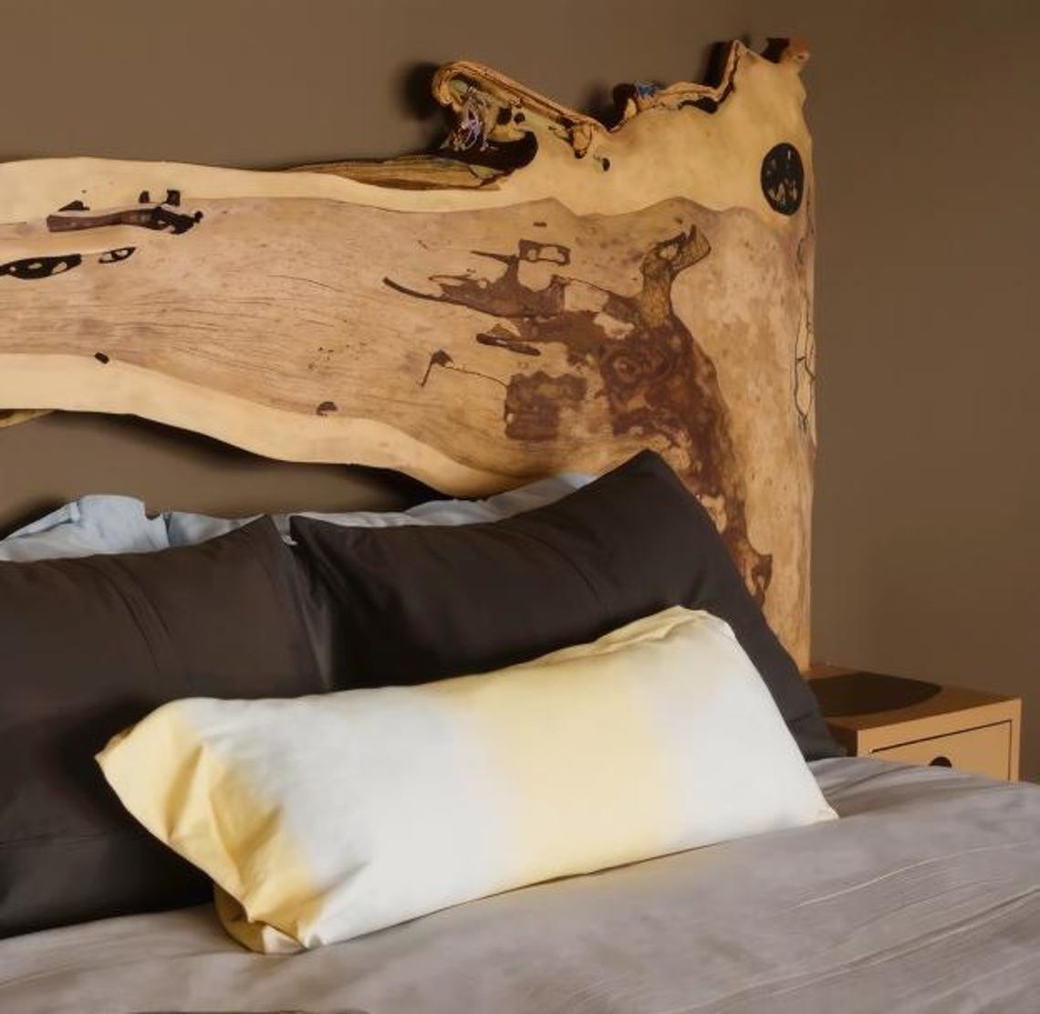 Live edge wooden headboard with built-in shelf in a modern bedroom setting, featuring natural wood grain and organic design-2